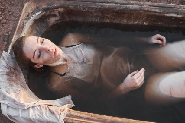 istock Depressed woman lying in dirty bath 1340014859