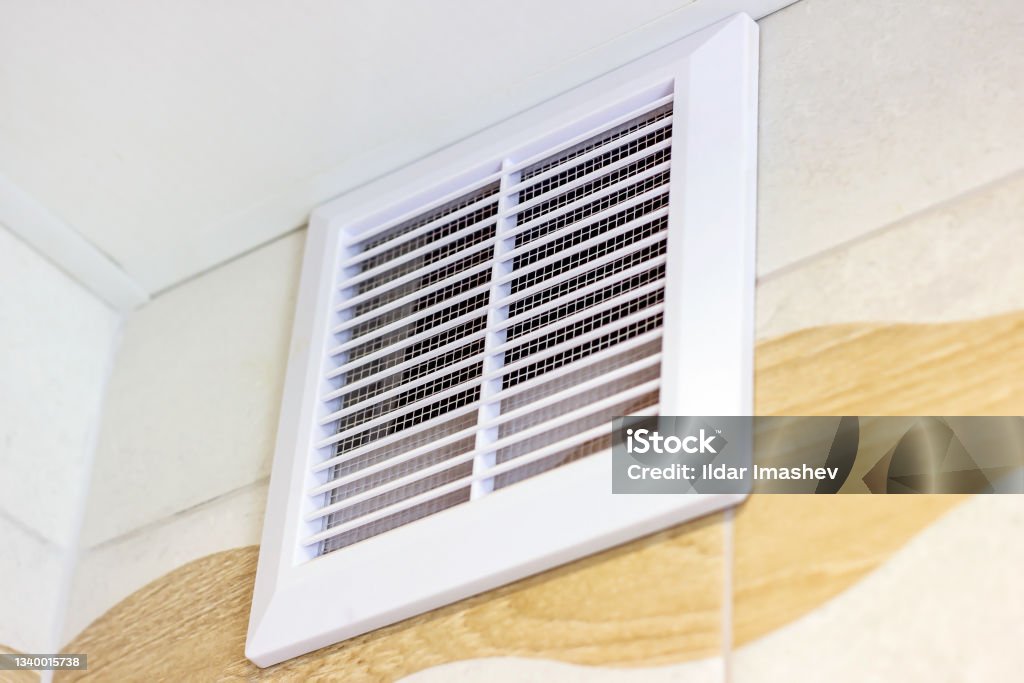 White plastic ventilation panel in the bathroom for air circulation White plastic ventilation panel in the bathroom for air circulation. Air Duct Stock Photo