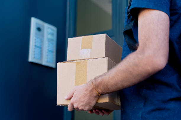 istock Close up of delivery man delivering parcel box. 1340015914