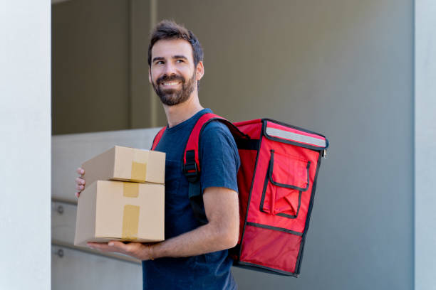 istock caucasian delivery man delivering parcel box. 1340015948