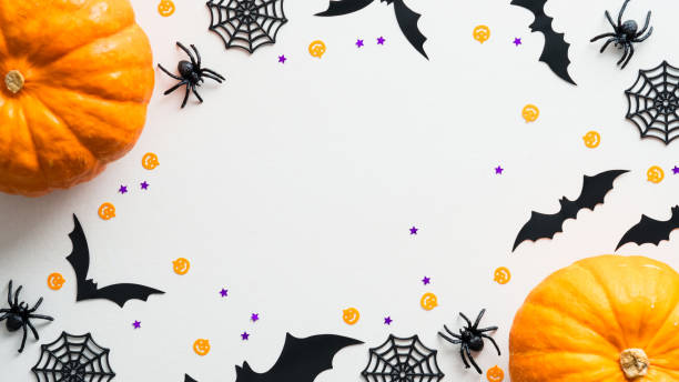 istock Happy Halloween holiday flat lay composition with pumpkins, spiders, bats on white background. Halloween banner mockup, greeting card design. 1340016818