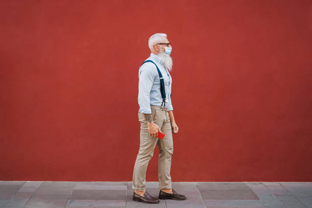 istock Hispter senior man walking around the city using safety mask - Focus on face 1340019696