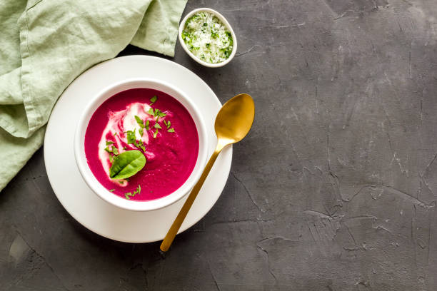 Cream soup made of red beet roots with basil stock photo