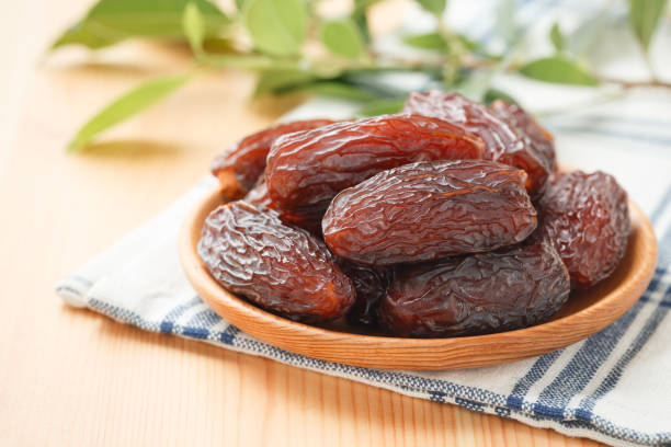 istock Date fruit in wood bowl on placemat 1340022328