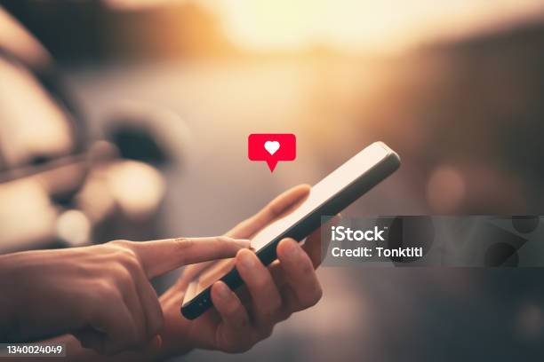 Close Up Woman Hand Hold Using Smart Phone With Heart Icon At Outdoor Park Street Background Copy Space Of Technology Business And Travel Holiday Concept Stock Photo - Download Image Now