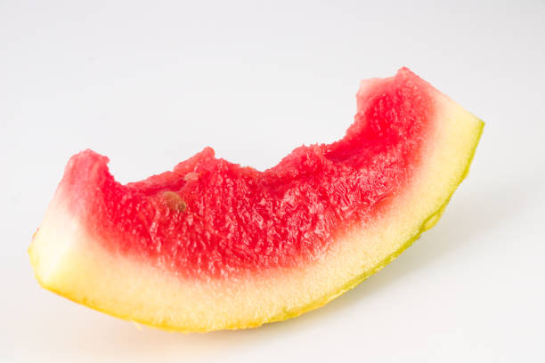 istock Eaten slice of watermelon isolated on white background 1340025609
