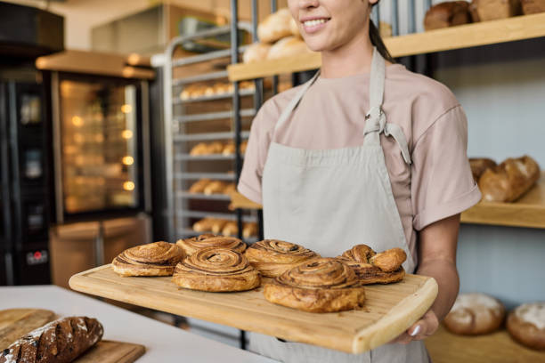 istock Holding wooden tray with fresh appetizing pastry 1340025680