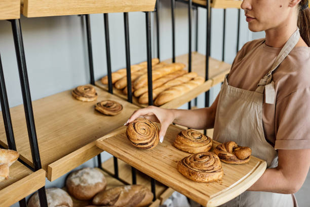 istock Woman with tray in bakery 1340025689