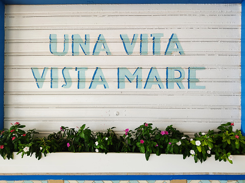 italian quote painted on white damper about sea vacations, 