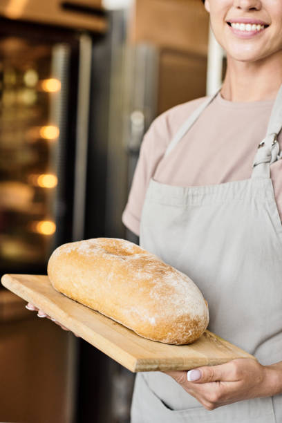 istock Bakery worker with loaf of bread 1340026713