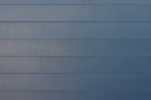 Wooden garage door with repeating pattern.