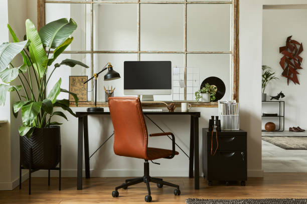 istock Creative workspace composition of modern masculine home office interior with black industrial desk, brown leather armchair, laptop, vintage record player and stylish personal accessories. Template. 1340028379