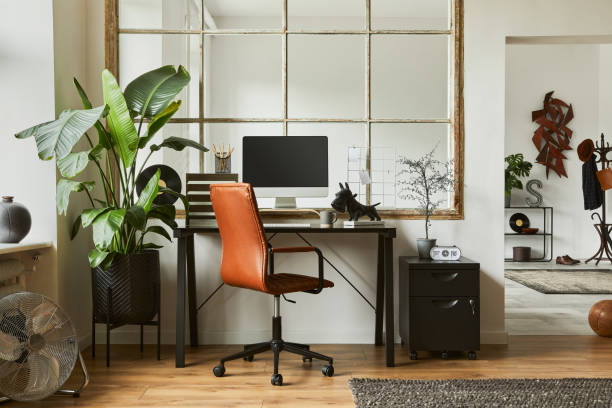 istock Creative workspace composition of modern masculine home office interior with black industrial desk, brown leather armchair, laptop, vintage record player and stylish personal accessories. Template. 1340028386
