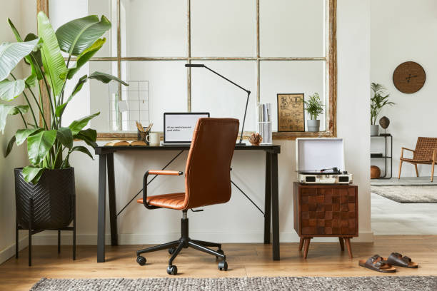 istock Creative workspace composition of modern masculine home office interior with black industrial desk, brown leather armchair, laptop, vintage record player and stylish personal accessories. Template. 1340028390