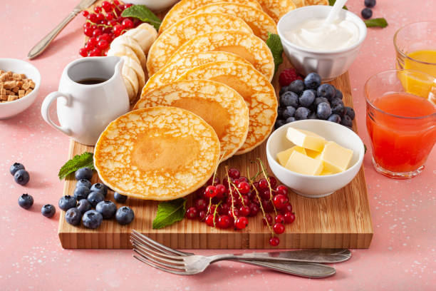 american pancake board with bacon berries maple syrup butter
