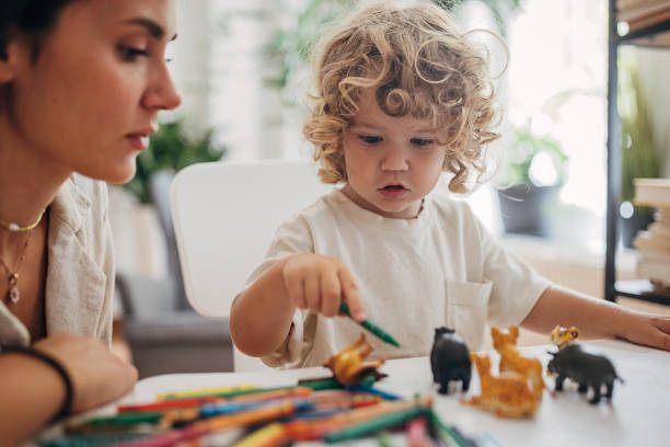 istock Mom and little son playing together 1340029775