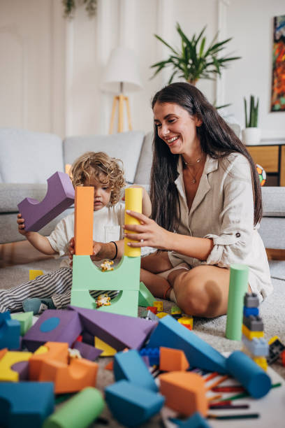 istock Little boy and mom playing on the floor 1340029909