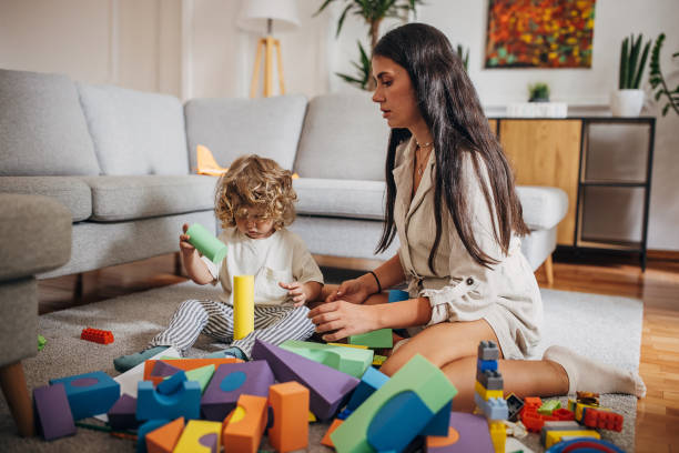 istock Little boy and mom playing on the floor 1340030068