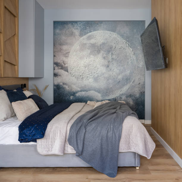 istock Small bedroom with wooden wall and moon poster 1340030236