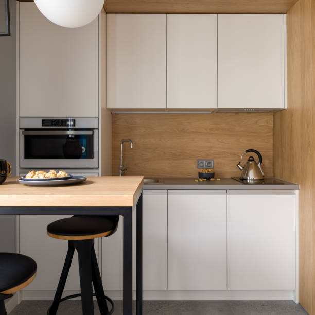 istock Small and stylish kitchen with white furniture 1340030242