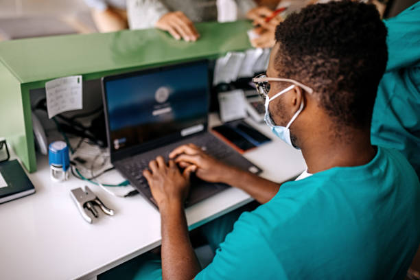istock Male receptionist working at a hospital 1340030337
