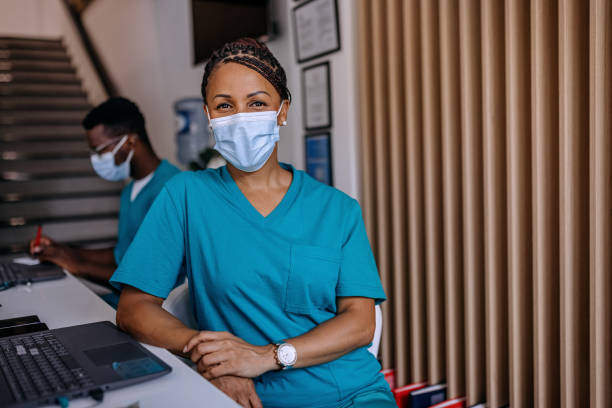 feliz enfermera trabajando en el hospital - ayudante fotografías e imágenes de stock