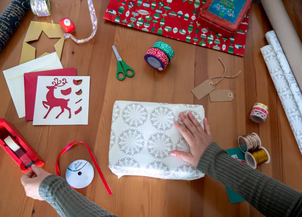 istock Woman hands wrapping a Christmas gift 1340034981
