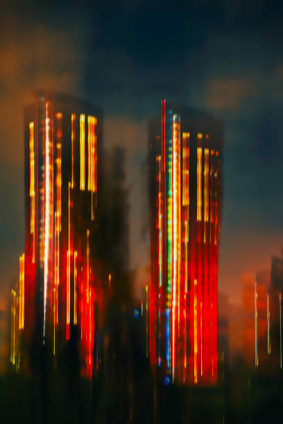 istock Blurred view of modern two skyscraper, glowing building at night, abstract background 1340038215