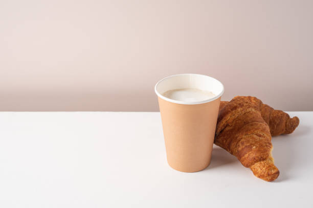 istock Paper cup of coffee and croissant 1340039751