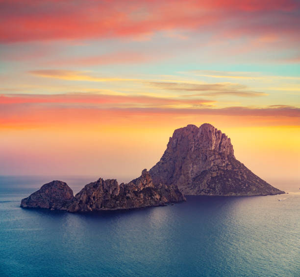 Es Vedra islet sunset in Balearic Islands Es Vedra islet sunset in Sant Josep of Balearic Islands ibiza island stock pictures, royalty-free photos & images