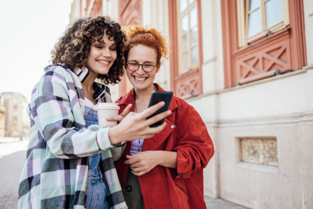 istock Two girls using smartphone on the move and having fun 1340042879