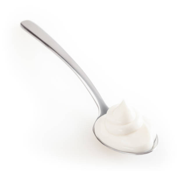 istock Spoon of mayonnaise isolated on white background with clipping path 1340043799