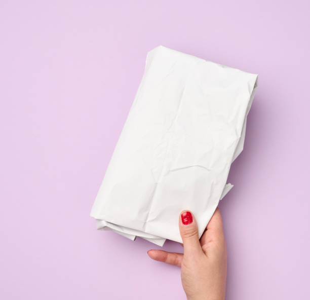 istock hand hold folded wrapping crumpled white paper on purple background 1340045400