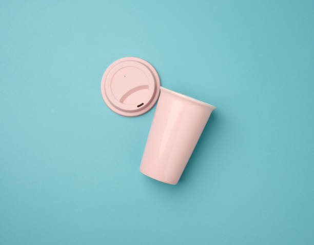 istock empty pink ceramic cup with rubber lid for cappuccino and coffee on blue background 1340045655