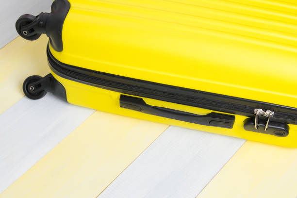 istock on a gray-yellow background, a travel suitcase, close-up 1340045890