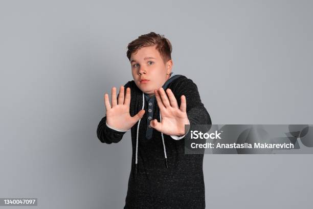 Teen Boy With Scared Facial Expression Can Feel Disgusted When They See Things That Make His Sick Refusal Or Rejection Concept Stock Photo - Download Image Now