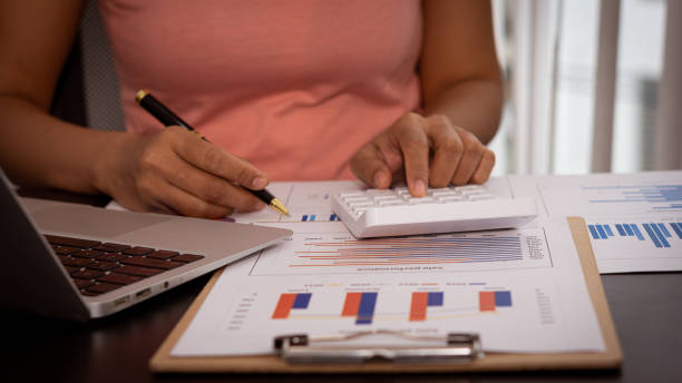 istock Businessman holding a pen pointing to an analysis graph, investment planning, work projects and business discussion strategies. 1340047337