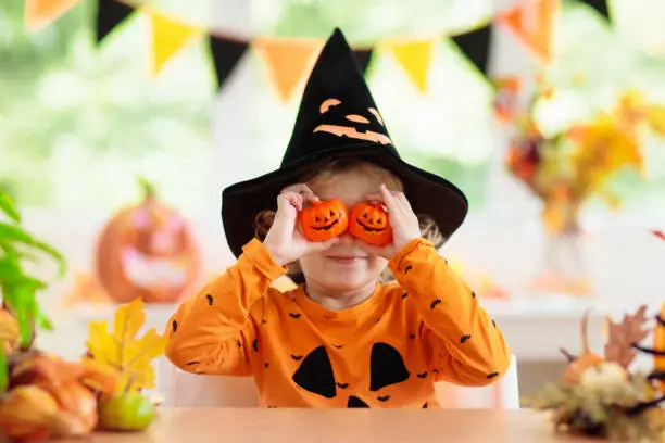 Photo of Child in Halloween costume. Kids trick or treat.