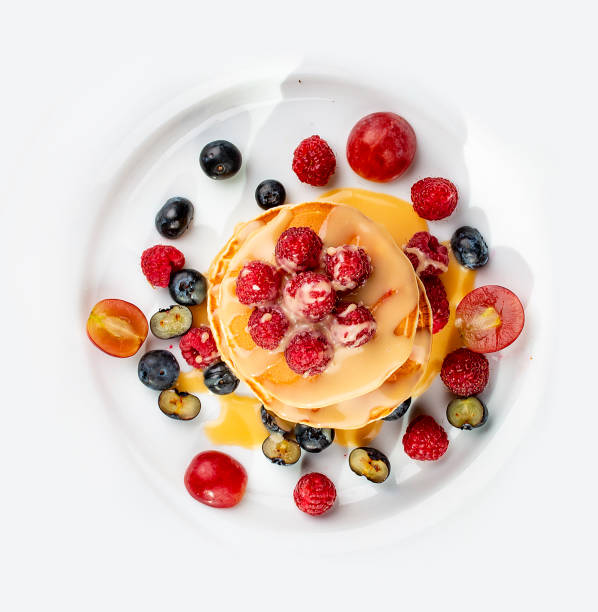 istock Pancakes with caramel and seasonal berries on a white background. Breakfast 1340047549