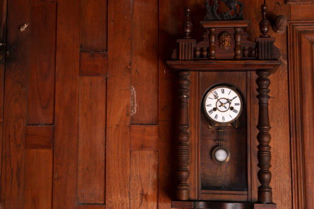 istock antique pendulum clock hanging on the wooden wall 1340049273