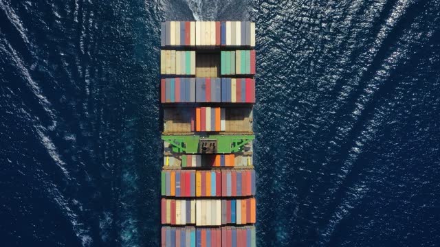 High aerial top down view to a heavy loaded container cargo vessel