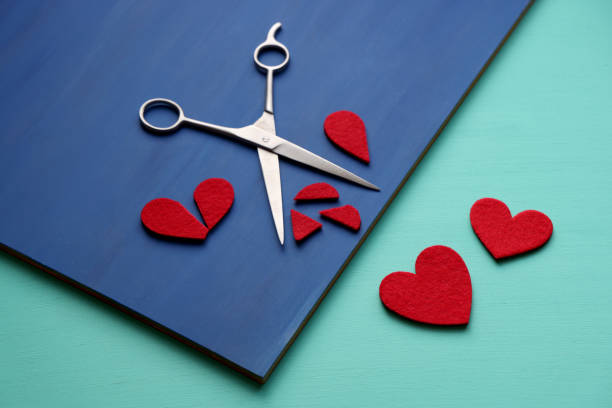 istock Cut out heart shapes and scissors 1340056598