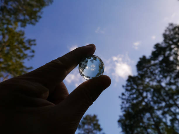 A crystal marble A crystal marble with a refrection of trees and sky. climate justice photos stock pictures, royalty-free photos & images