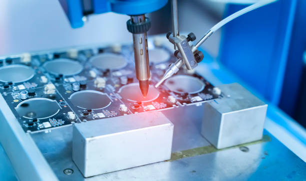 istock automatic robot for print circuit board (PCB)assembly machine during soldering or welding part 1340058251