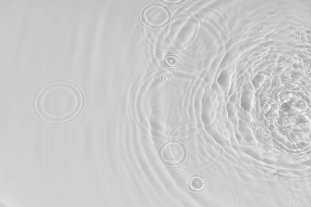 istock Water tranquil ripple background. Water texture, circles and bubbles on a liquid white surface. Cosmetic products and flat design concept 1340058991