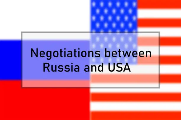 Negotiations between Russia and USA - words in a frame on a blurred background of the flag of Russia and the USA