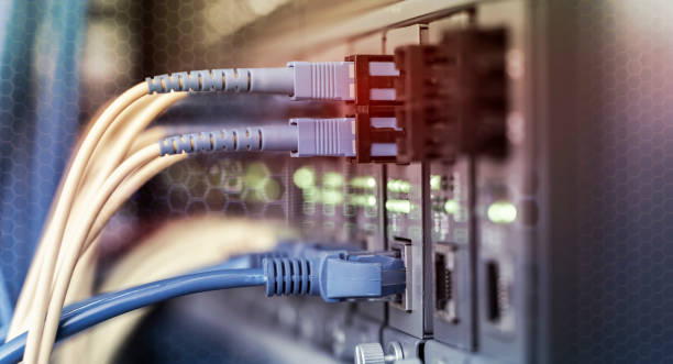 istock Fiber Optical cables connected to an optic ports and Network cables connected to ethernet ports 1340060083