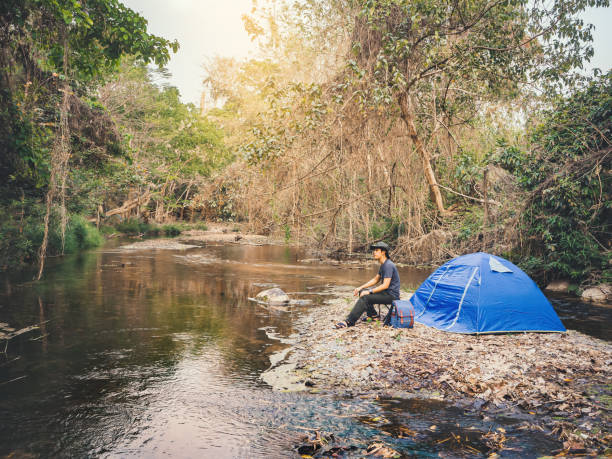 istock Summer camping near stream in tropical forest 1340061004