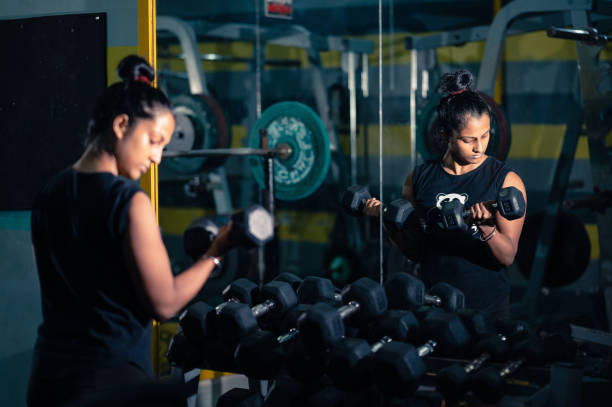 istock Young Woman does dumbbell workout in a gym. 1340063609