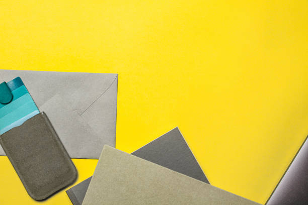istock A workplace in an office with a yellow desk. Top view of a laptop with a notebook, a case for glasses, a mouse. A space for modern designer creativity. The concept of business and finance. 1340066421